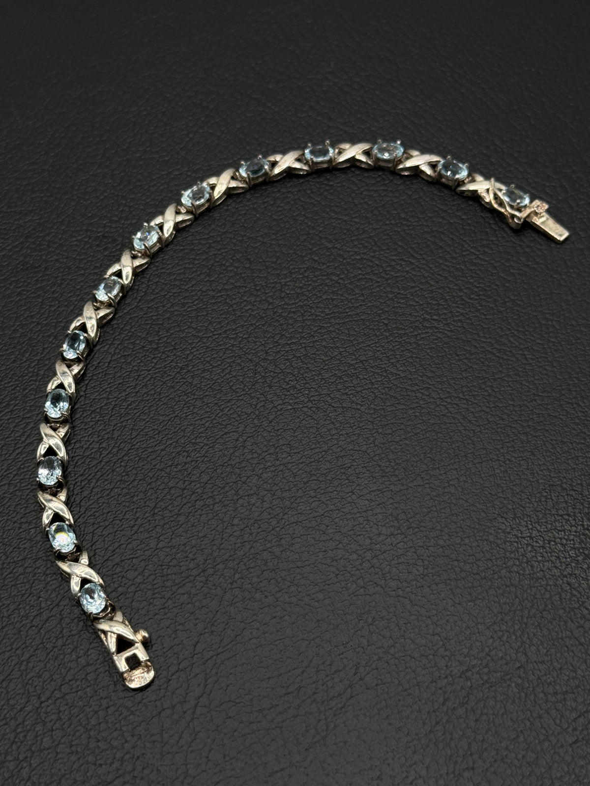 .925 Sterling Silver Light Blue Topaz Oval Stone X Link Tennis Bracelet – 7.5”