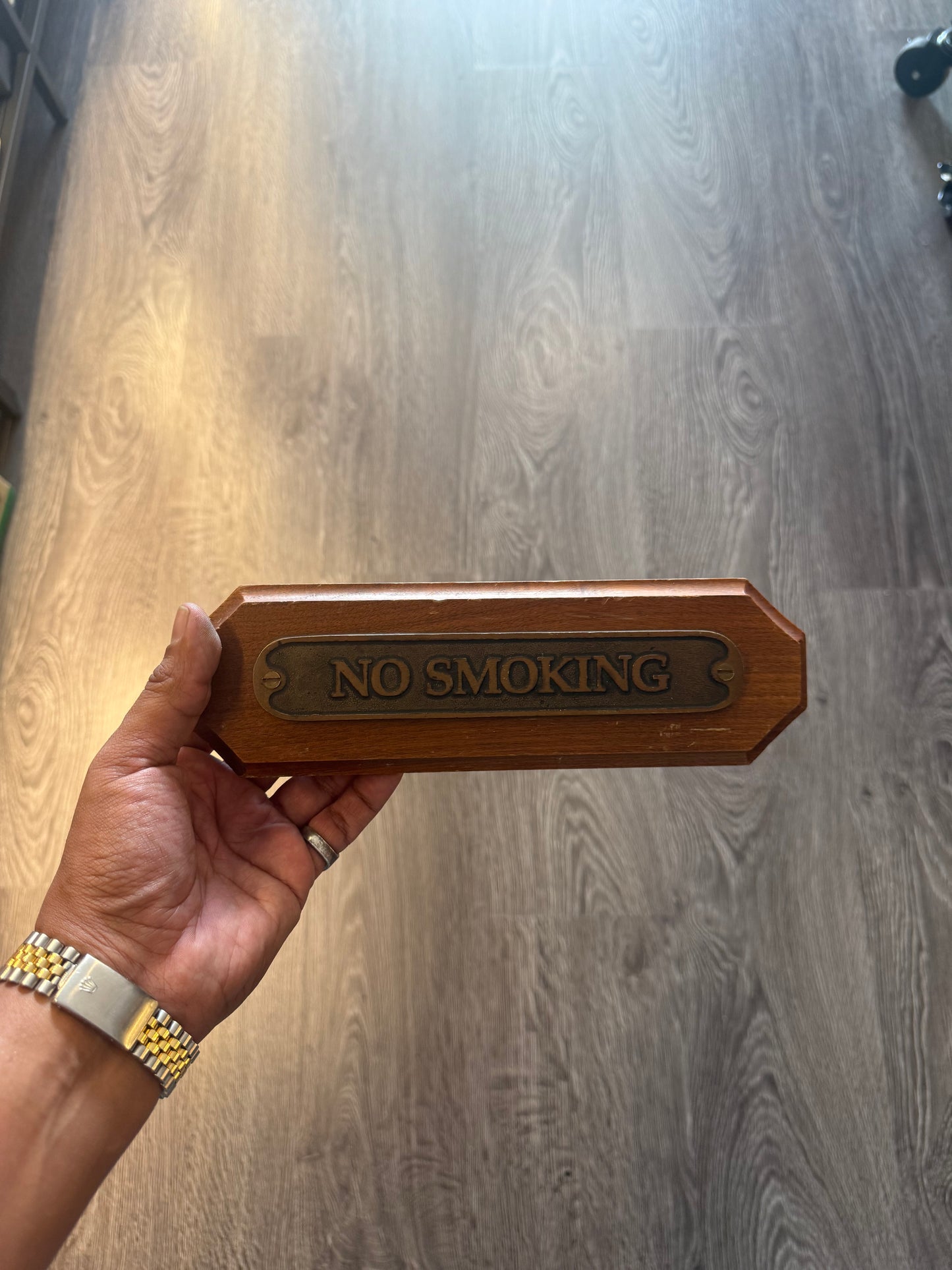 “No smoking” brass wooden sign