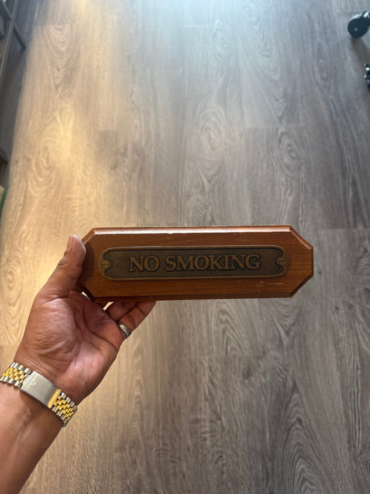 “No smoking” brass wooden sign