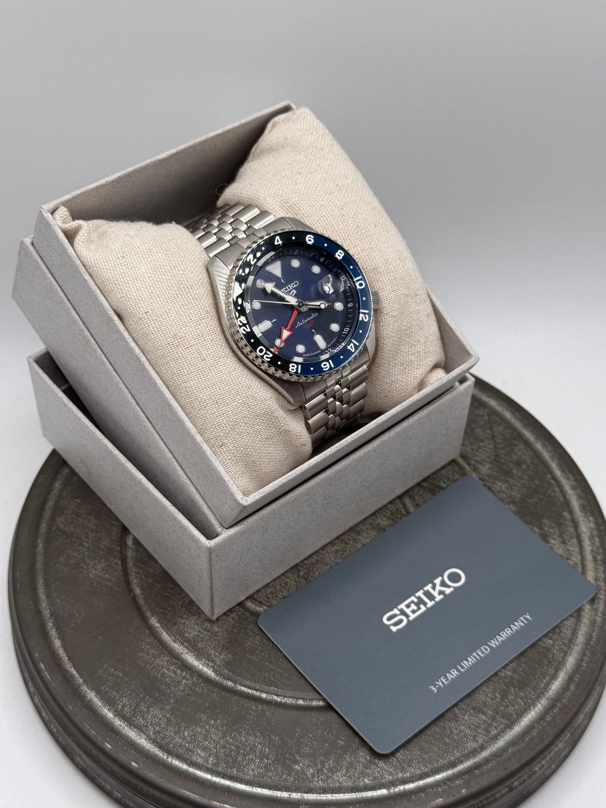 Seiko 5 Sports GMT Automatic Watch – Black Dial, Blue & Black Bezel, Stainless Steel Jubilee Bracelet with Box